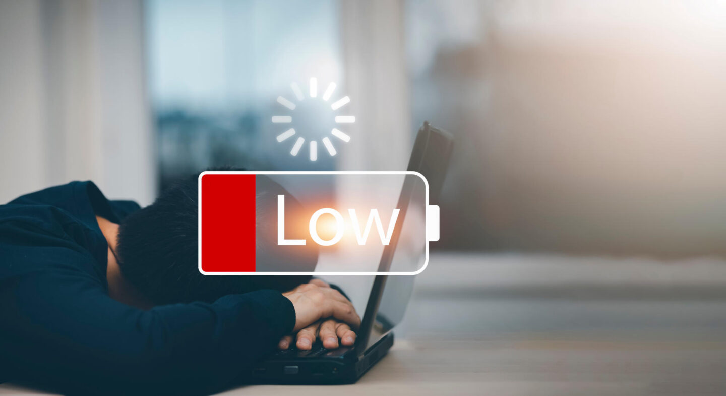 Businessman pressing button Low battery of energy with people icon concept Saving on working with empty battery symbolTired from work and stress concept Empowering ideas and teamwork