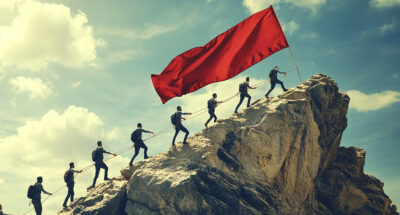 A minimal style of a red down graph of the financial crisis, economic downturn, inflation, recession, bankruptcy, and crisis concept. Businessmen team push to resist a domino effect to stop failure.